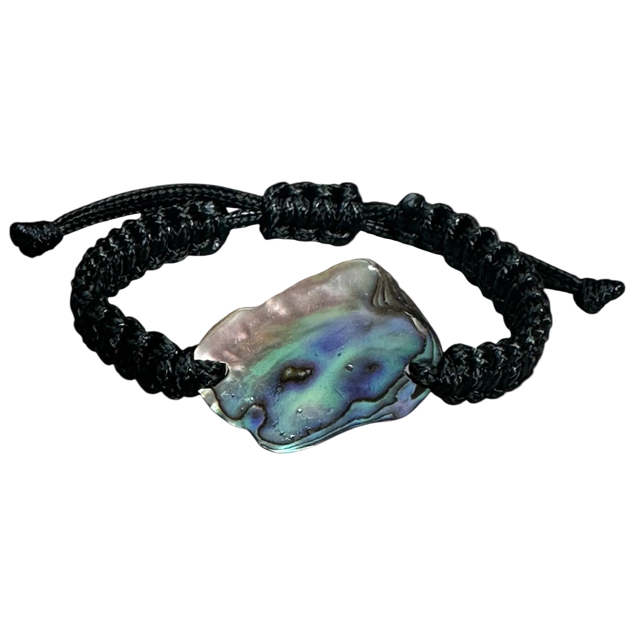 Black polyester knotted bracelet with vibrant NZ Paua shell, photographed on a stone background.
