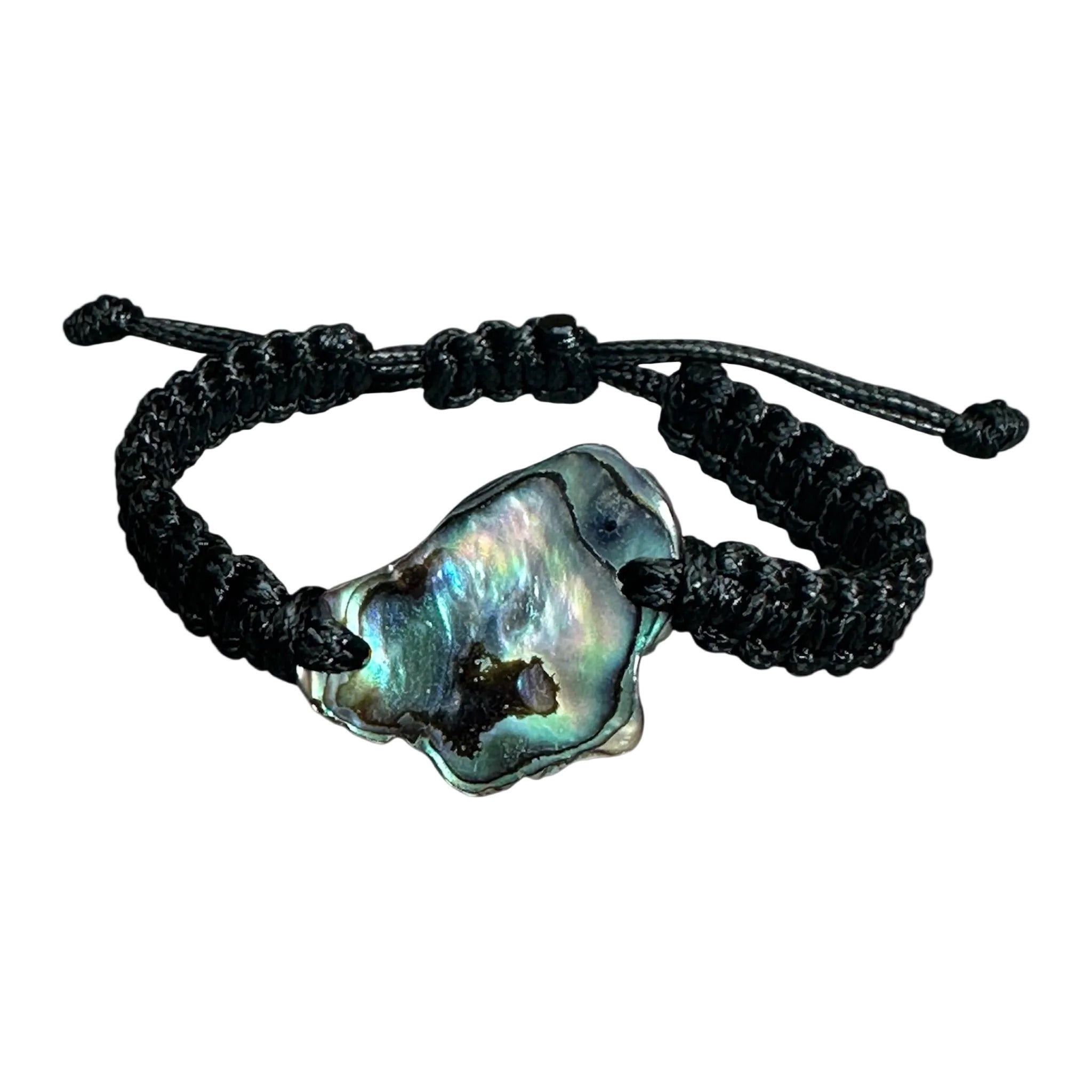 Paua shell bracelet with square black knots, laid flat to highlight the natural iridescence.